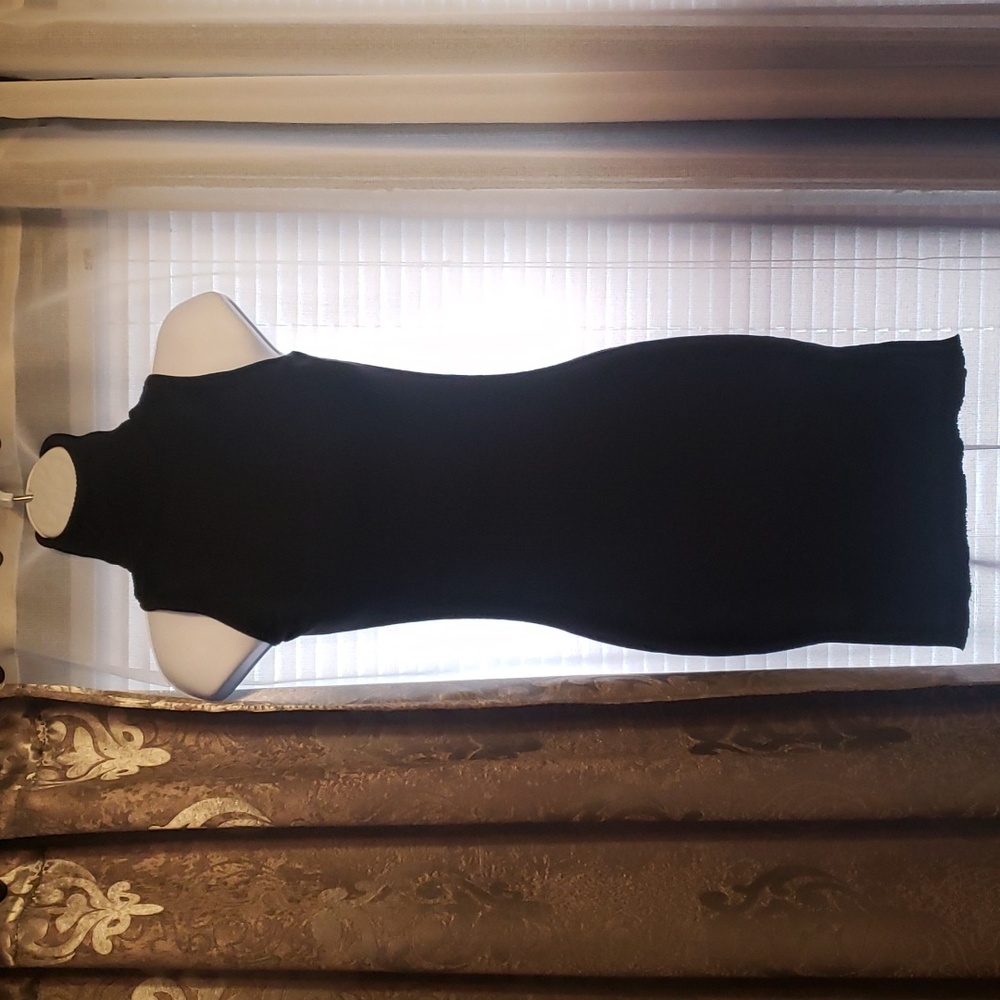 Black turtle neck sleeveless sweater dress w open back. Studded criss cross back